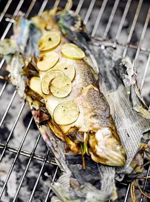 Barbecued trout in newspaper